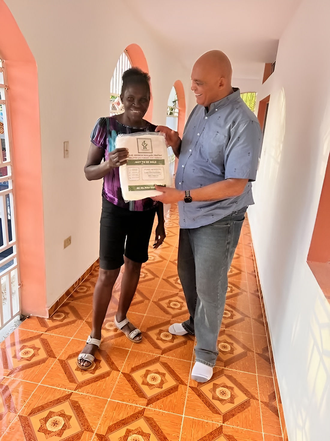 A Fight Malaria insecticide-treated bed net handed directly to a woman